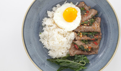 Rice with sunny side eggs, stir-fried beef and basil. One of the most popular Thai dishes.
