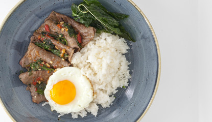 Rice with sunny side eggs, stir-fried beef and basil. One of the most popular Thai dishes.