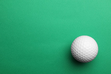 Golf ball on color background, top view. Space for text