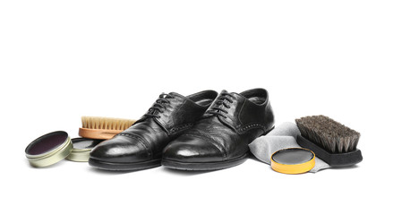 Stylish men's footwear and shoe care accessories on white background