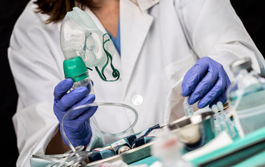Nurse prepares oxygen mask in hospital, conceptual image