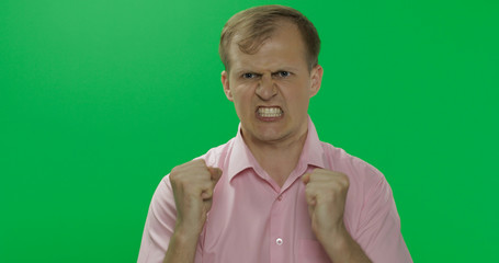 Angry aggressive young man in shirt nervous emotions. Chroma key