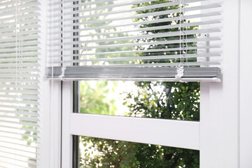 Open white horizontal window blinds, closeup view