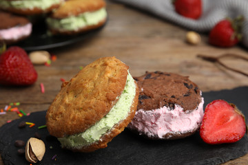 Sweet delicious ice cream cookie sandwiches on table
