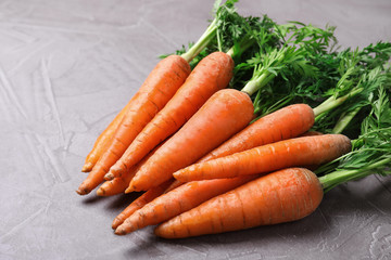 Bunch of fresh carrots on stone background