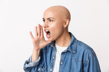 Beautiful screaming angry bald woman posing isolated over white wall background.