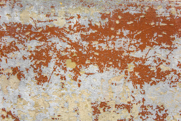 old shabby gray white concrete wall with scratches and brown red peeling paint. rough surface texture