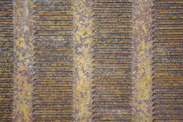 old rusty yellow gray brown metal grille ventilation louvers. rough surface texture
