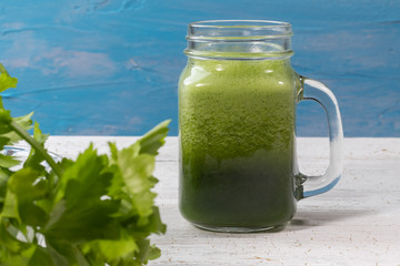 close up of fresh green celery juice on glass