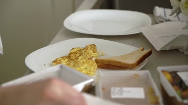 Man cooking breakfast at the kitchen