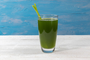 close up of fresh green celery juice on glass