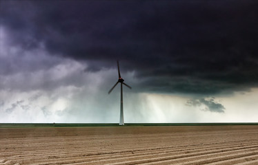 shower rain cloud over windmill