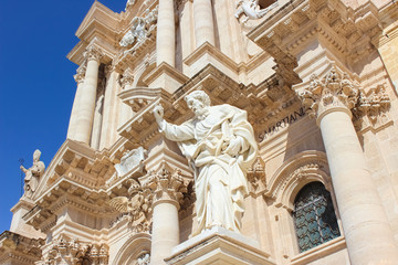 Detail of the front facade of impressive Syracuse Cathedral on Piazza Duomo Square in Syracuse, Sicily, Italy. Statues with religious motifs. Sculptures. Baroque architecture. Ortigia Island