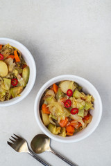Vegetable stew of carrots, potatoes, cabbage and zucchini with hot peppers