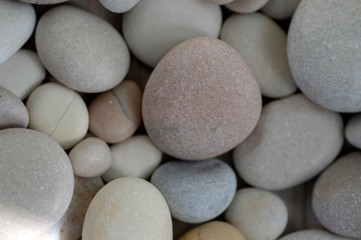 Group of white, grey and light brown stones background, pebbles beach
