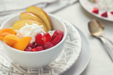 Sliced strawberry, apricot and apple with cottage cheese and sour cream