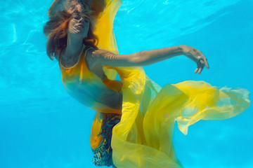 Underwater shoot of woman in yellow 