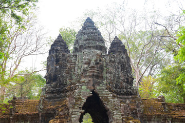 Fototapeta na wymiar detail view of ancient stone gate in the jungle with giant faces in Cambodia