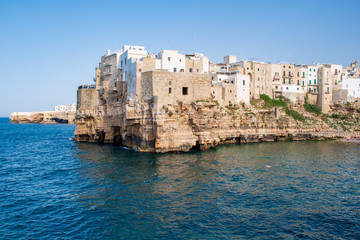 Panoramic city skyline with white houses of Polignano a Mare, town on the rocks, Puglia region, Italy, Europe. Traveling concept background with blue Mediterranean sea