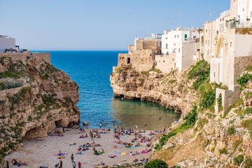 Panoramic city skyline with white houses and beach, town on the rocks, Puglia region, Italy, Europe. Traveling concept background with blue sea