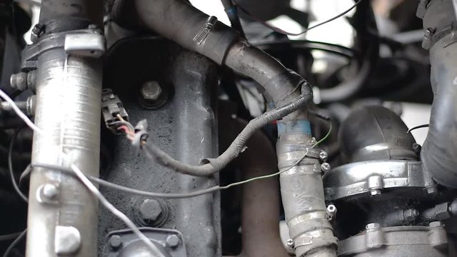 Timing belt alternator belt in motion on a running car engine. Car engine. The engine of the vehicle c of the rotating shafts of the gears and belt 
