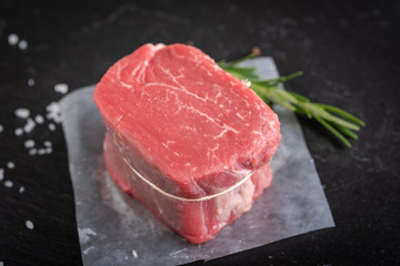 raw fillet mignon with rosemarry, salt and pepper