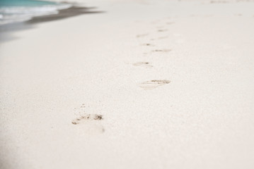 FOOTPRINTS IN THE SAND ON A BEACH