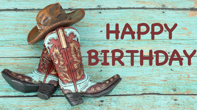 teal and brown cowboy boots and hat laying flat on a wooden teal background with happy birthday in brown text