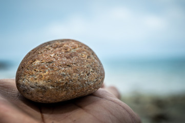 Fototapeta na wymiar Rock on hand at the beach Koh Samet