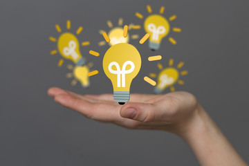  holding illuminated light bulb, idea, innovation and inspiration concept.
