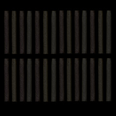 Cigars on a dark background. Cigars in the dark. Background of evenly spaced cigars.