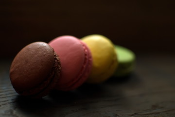 Multi-colored macaroons on a wooden tray. Pink, yellow and green macaroon. - 272862654