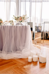 Wedding in the style vintage. Decoration of the table with flowers and cutlery. Composition from flowers. Elegant dining table in peach-purple color. Indoors wedding reception venue with festive decor