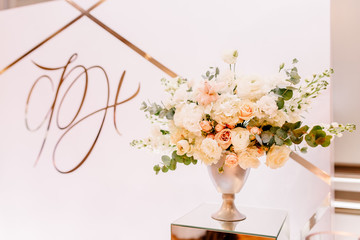 Wedding in the style vintage. Ceremony decoration with candles, a candlestick and flowers. Background with an inscription and mirror nightstands.
