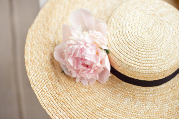 top view of straw beach hat on wood background