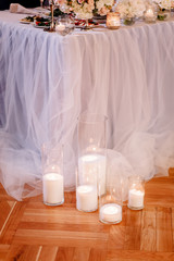 Wedding in the style vintage. Decoration of the table with flowers and cutlery. Composition from flowers. Elegant dining table in peach-purple color. Indoors wedding reception venue with festive decor