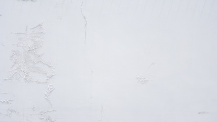 White old weathered painted wall of cement background texture