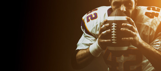 Portrait close-up, American football player, bearded without a helmet with the ball in his hands....