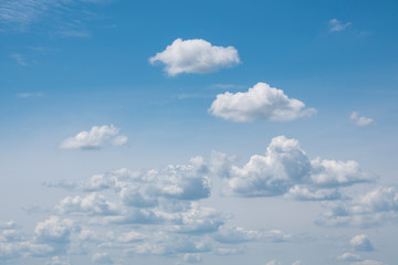 White clouds on the blue sky. Abstract background with clouds on blue sky. In the clear sky high floating clouds.