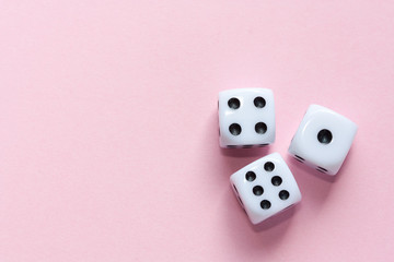 Gaming dices on pink background.