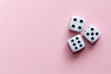 Gaming dices on pink background.