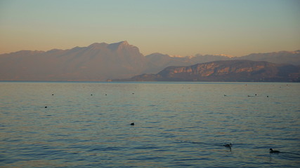 View of Lake Garda: beautiful blue water, sky and sharp mountain peaks (Alps and Dolomites)