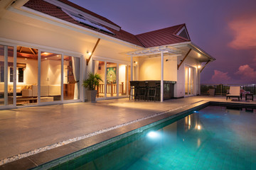 home or house Exterior design showing tropical pool villa with sun bed - obrazy, fototapety, plakaty