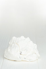 photo of a white Bizet cookie on a white wooden table and an isolated white background. Photo of the dessert for the menu