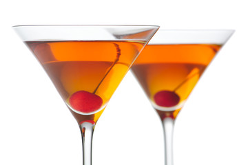 Manhattan drinks with red cherry on white