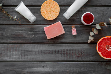 Natural herbal cosmetics with grapefruit on wooden background top view space for text