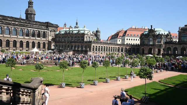 Timelapse footage in Zwinger palace, Saxony, Dresden. Happy holiday with large crowd of people, blue sky, sunny day in Zwinger.
