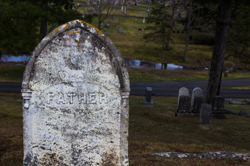 Old gravestone with  Father on it.