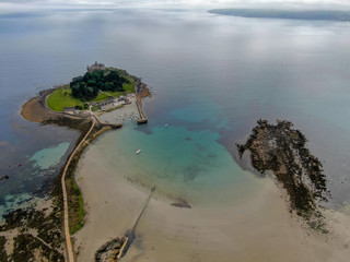 Obraz premium Aerial view St Michael's Mount is a small tidal island in Mount's Bay, Cornwall, England, United Kingdom. Castle and chapel on the top of the mount. 