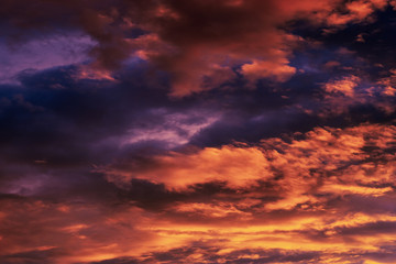 Naklejka na ściany i meble Dramatic fiery sky at sunset before a thunderstorm